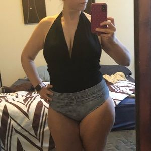 Cute black one piece with plunging neckline.